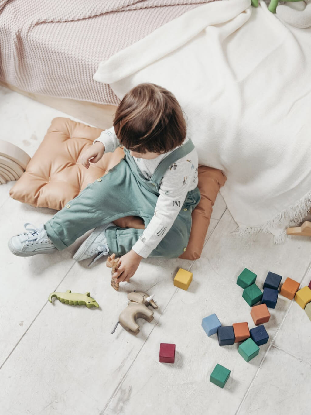 a toddler playing with wooden blocks