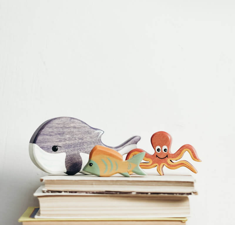 a trio of ocean themed wooden toys