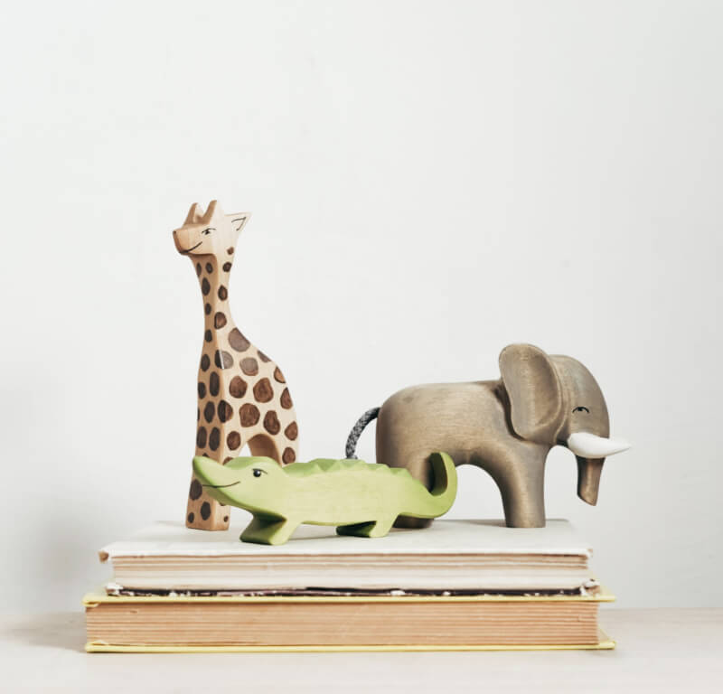 a trio of safari themed wooden toys